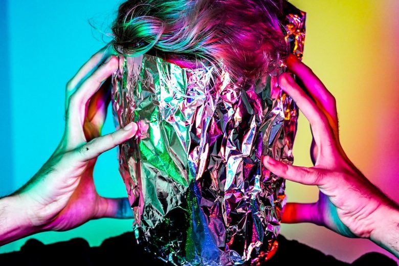A person's head wrapped in aluminium foil which indicates a creative block