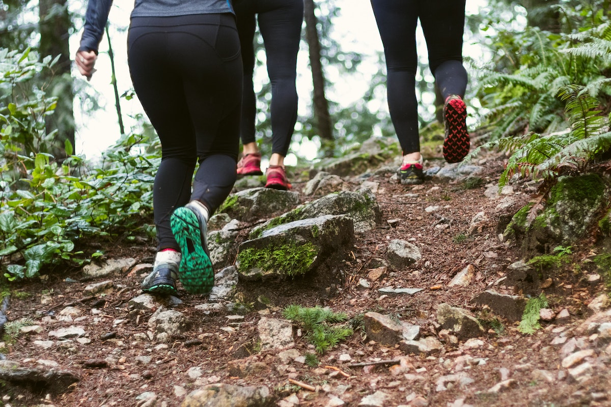 A group of people jogging up a hill